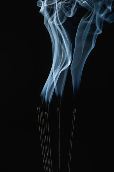 Burning aroma sticks with smoke on black background — Stock Photo