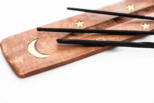 Close up view of aroma sticks on wooden stand with moon and stars on white background — Stock Photo