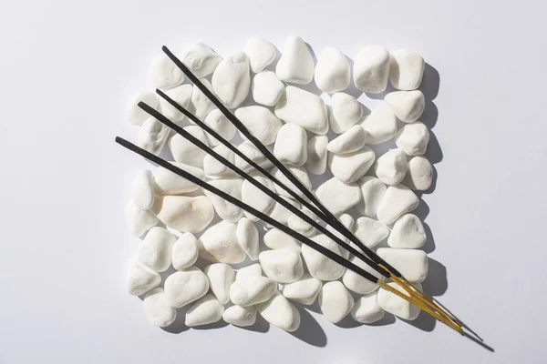 Top view of aroma sticks on square made of stones on white background, panoramic shot — Stock Photo