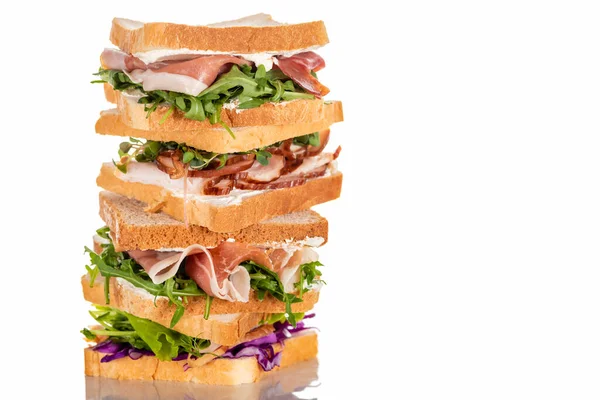 Fresh sandwiches with arugula and meat on white surface — Stock Photo