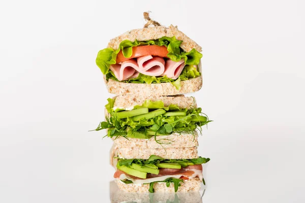 Fresh green sandwiches with avocado and meat on white surface — Stock Photo