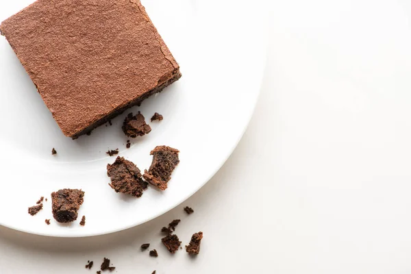 Top view of delicious brownie piece on plate on white background — Stock Photo