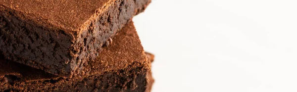 Delicious brownie pieces on white background, panoramic shot — Stock Photo