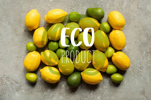 Top view of colorful avocado, limes and lemons on grey concrete surface, eco product illustration — Stock Photo