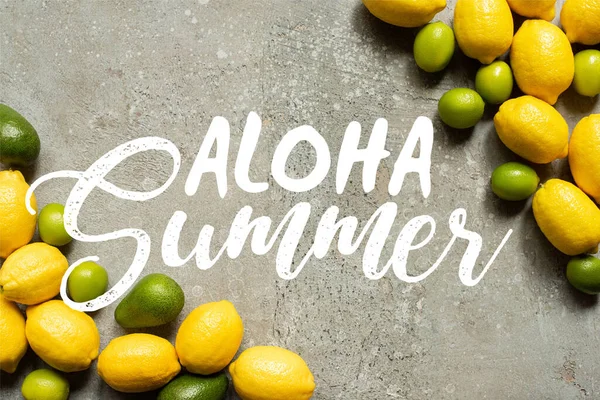 Top view of colorful avocado, limes and lemons on grey concrete surface, aloha summer illustration — Stock Photo