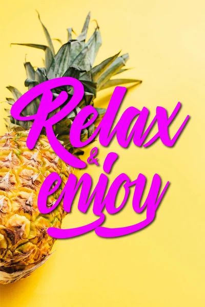 Fresh ripe pineapple on yellow background with relax and enjoy illustration — Stock Photo