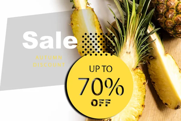 Top view of cut juicy pineapple on cutting board on white background with sale illustration — Stock Photo