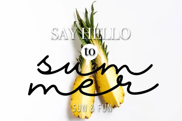 Top view of cut ripe pineapple with green leaves on white background with say hello to summer illustration — Stock Photo