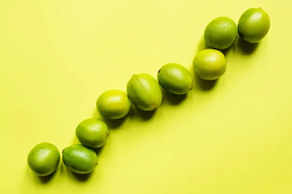 Top view of ripe limes on colorful background — Stock Photo