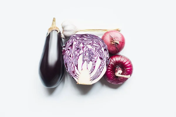 Top view of red onion, red cabbage, eggplant and garlic on white background — Stock Photo