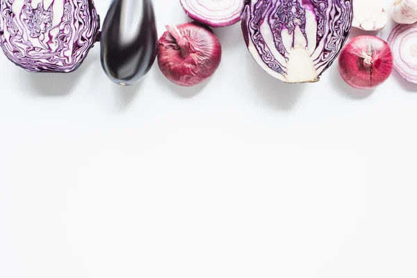 Border of red onion, red cabbage, eggplant and garlic on white background — Stock Photo