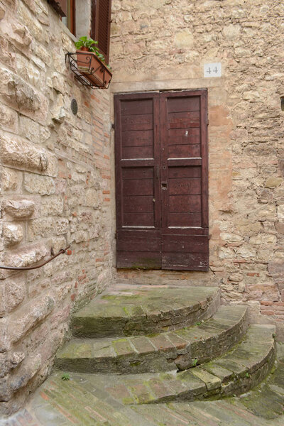 Brown front door in a stone house in Italy