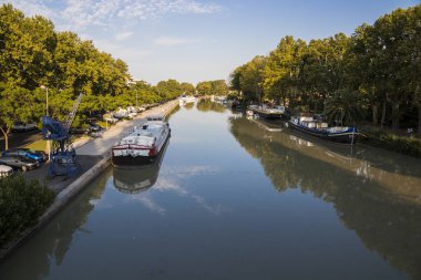 Bir vinç ve çeşitli longboats Canal du Midi adlı günbatımı, Beziers, Güney Fransa. 1996 yılından bu yana Dünya Mirası
