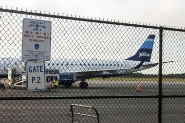 JetBlue Airways Corporation aircraft seen through a fence at Martha's Vineyard Airport (MVY), Massachusetts, United States clipart