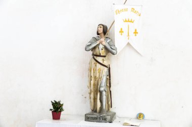 Ars-en-Re, France. Statue of Joan of Arc inside the Eglise Saint-Etienne church clipart