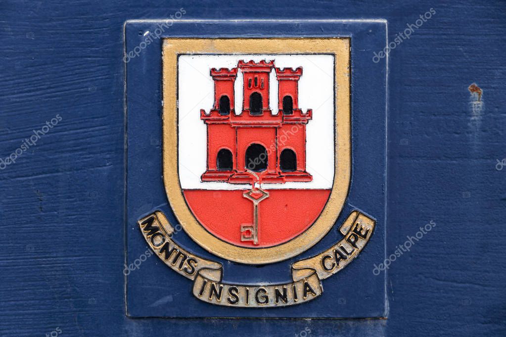 Gibraltar, U.K. Coat of arms of the British Overseas Territory of Gibraltar on a blue background