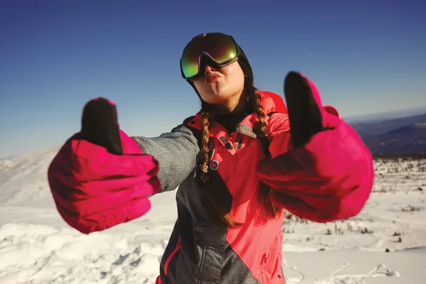 Young beautiful girl snowboarder with mask on her face holds thu — Stock Photo, Image