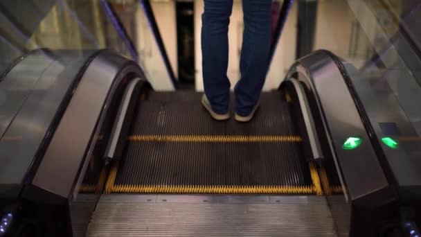 Ескалатор в торговому центрі, дівчина їде на ескалаторі — стокове відео