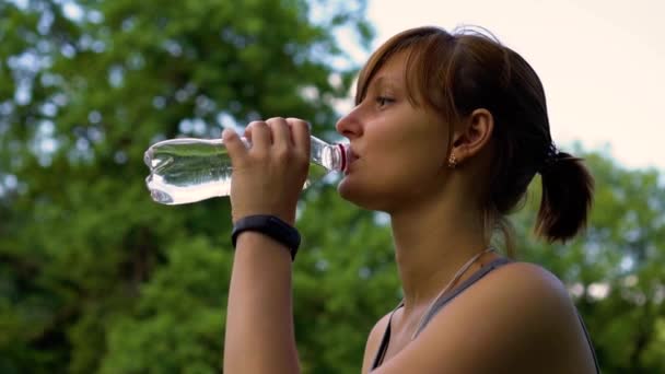 Chica en la naturaleza está bebiendo agua limpia — Vídeo de stock