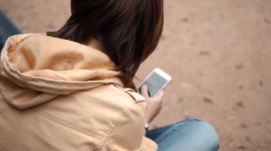 Parkta tek başına oturan genç bir kız.