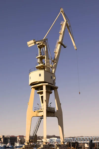 Mobile harbor cranes over blue sky. Transport and technology concept