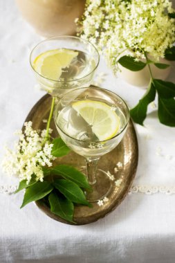 Limon ve elderflower soğuk bir içecek gözlük metal bir tepsi üzerinde şurubu. Rustik tarzı, seçici odak.