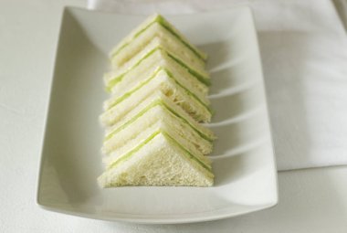 Salatalık ve tereyağı bir çay partisinde, İngiliz geleneği ile üçgen sandviç. Seçici odak.