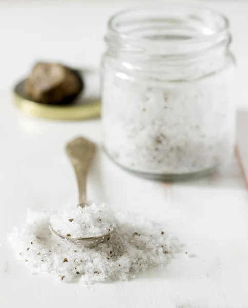 Sea salt with truffle and truffle on a light background. Rustic style, selective focus.
