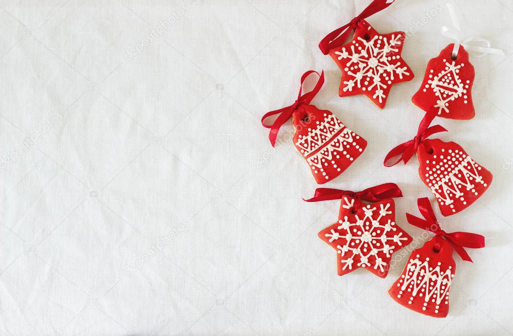 Christmas New Year holiday background, red gingerbread cookies on white table. Top view, copy space.