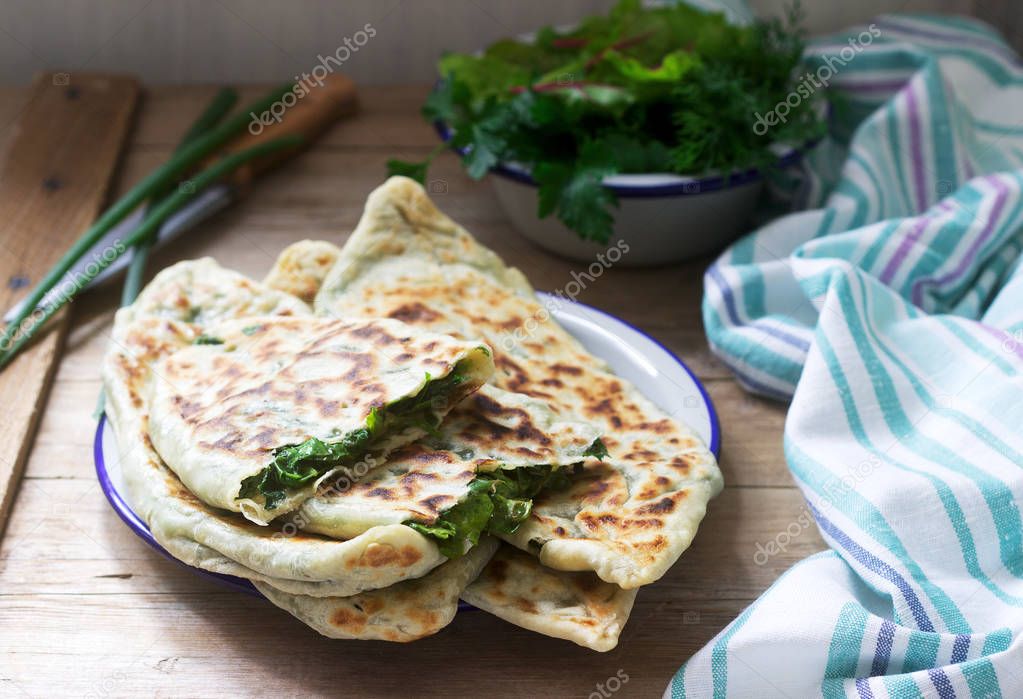 Baker making traditional dish of Armenians from Artsakh Zhingyalov hats is a type of flatbread stuffed with herbs.