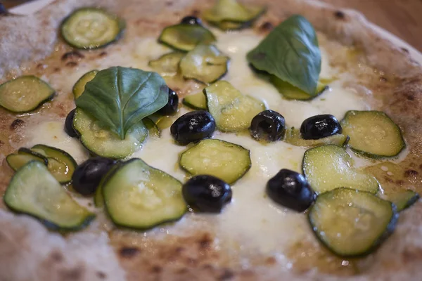 Pizza with zucchini and black olives