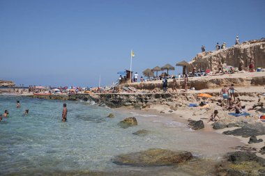 Ibiza, Balear Adaları, İspanya - 31 Ağustos 2015: Platges de Comte'da güneşlenen turistler