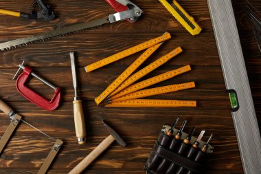 top view of different tools on brown wooden table clipart