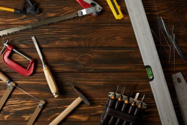 elevated view of different tools on brown wooden tabletop clipart