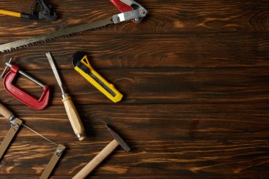 top view of different tools on brown wooden table clipart