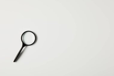 top view of single magnifying glass with handle isolated on grey 