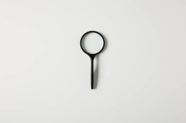 top view of single black magnifying glass with handle isolated on grey 