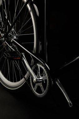 close-up view of pedals, chain and wheel of classic bicycle isolated on black clipart