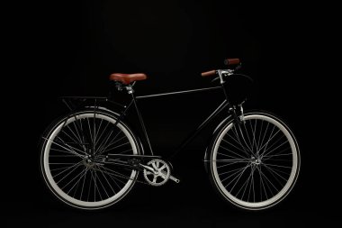 side view of classic vintage bicycle isolated on black  clipart