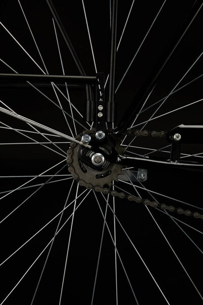 detail of bicycle wheel isolated on black, close-up view