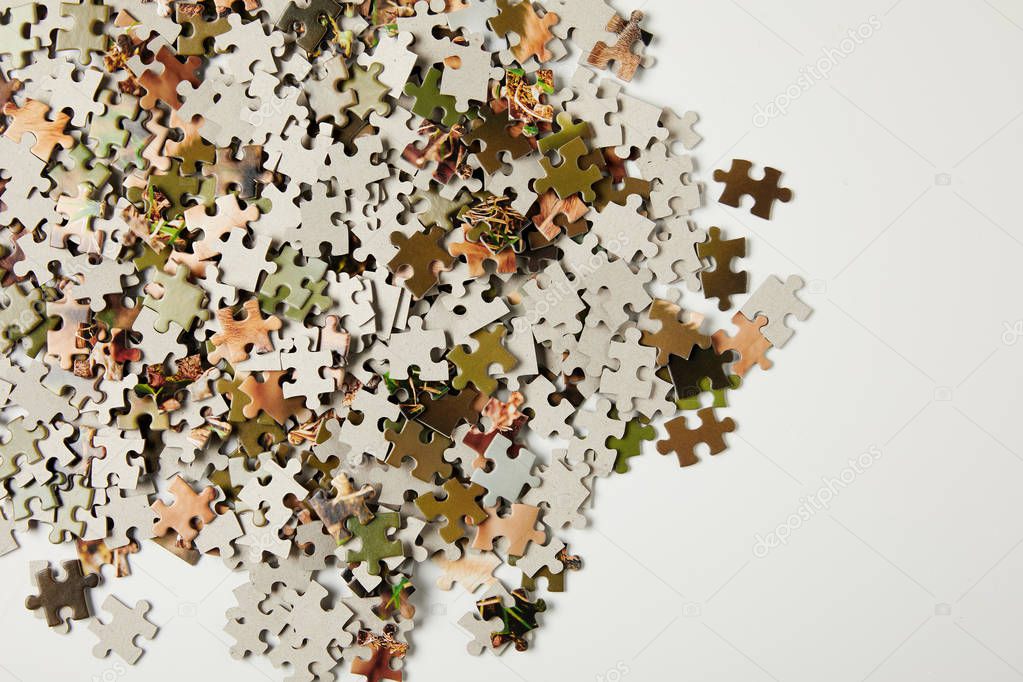 top view of jigsaw puzzle pieces with copy space on grey  