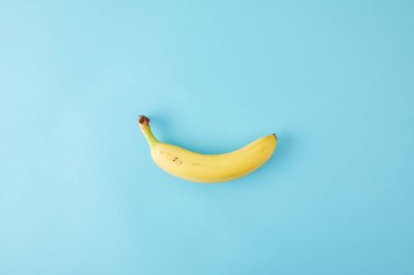top view of fresh banana isolated on blue clipart
