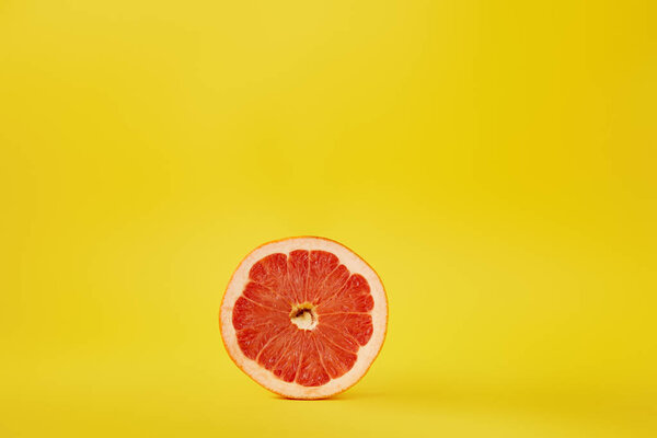 close up view of fresh ripe grapefruit isolated on yellow