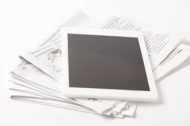 close up of pile of newspapers with digital tablet, on white clipart