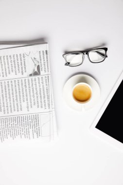flat lay with eyeglasses, coffee, digital tablet and newspapers, on white clipart