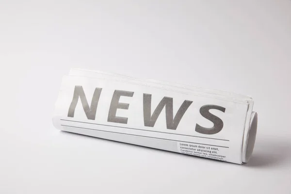 Rolled Newspaper Lying White Background — Stock Photo, Image