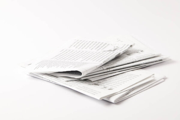 heap of black and white newspapers, isolated on white