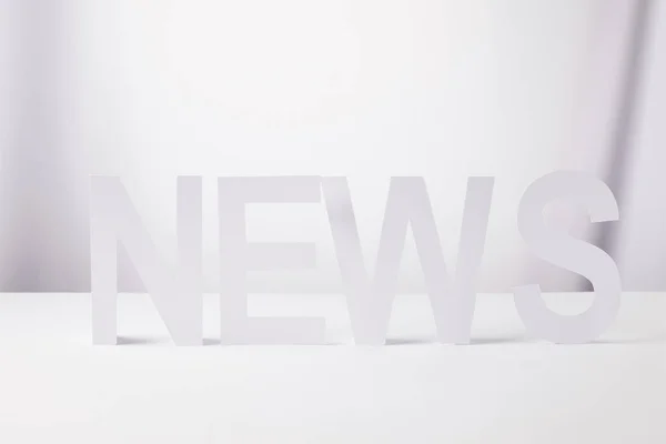 stock image minimalistic word news made of paper, on white background