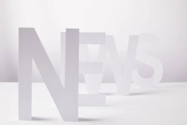 stock image selective focus of word news made of paper letters, on white background