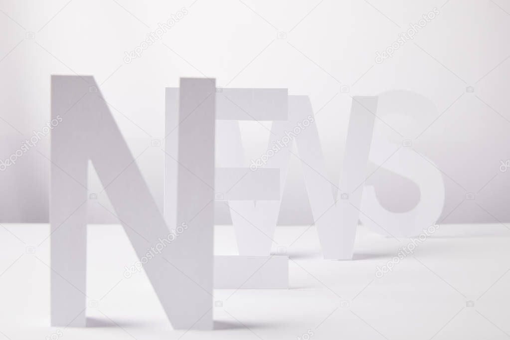selective focus of word news made of paper letters, on white background